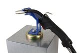 Blue magnetic holder supporting a MIG gun on a steel surface